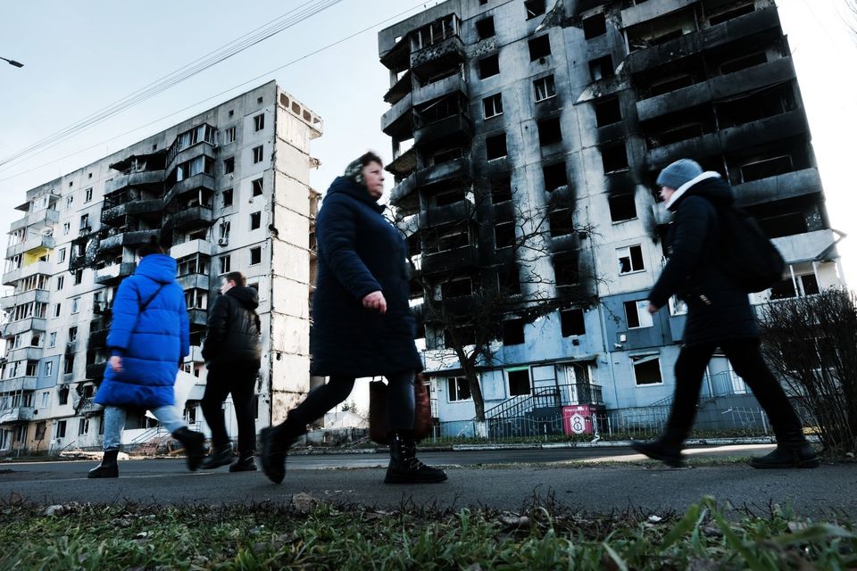 People walk through the partially destroyed town of Borodianka, Ukraine, on Jan. 2